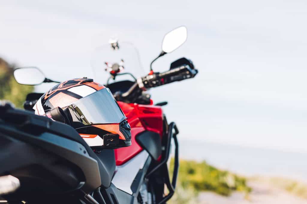 Adventure motorbike on grassy roadside. Offroad trip
