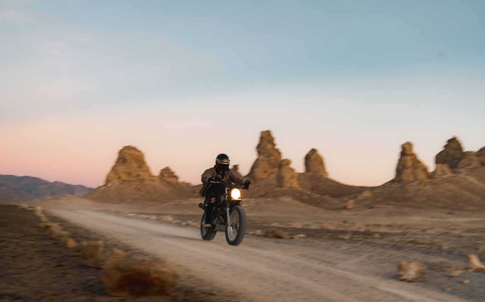 man riding motorcycle on road during daytime