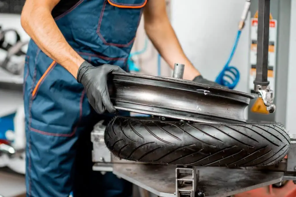 Worker changing a motorcycle tire