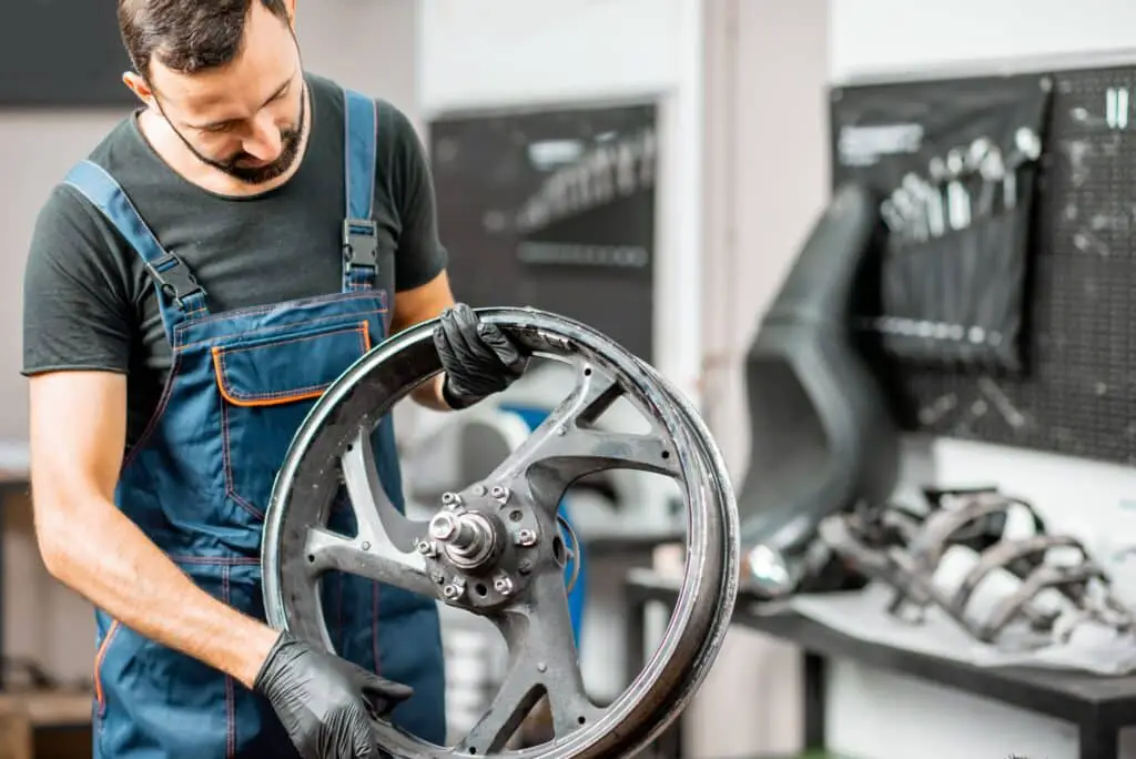 Worker changing a motorcycle tire