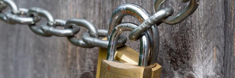 brown padlock on brown wooden fence