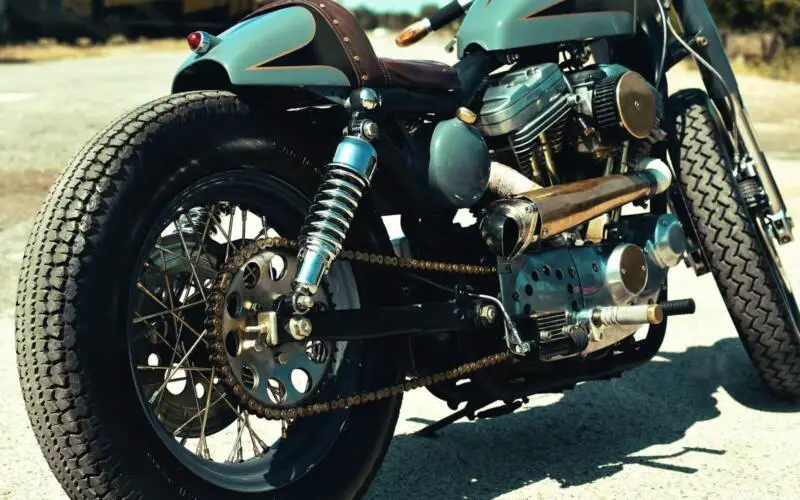 close-up photo of teal and black motorcycle